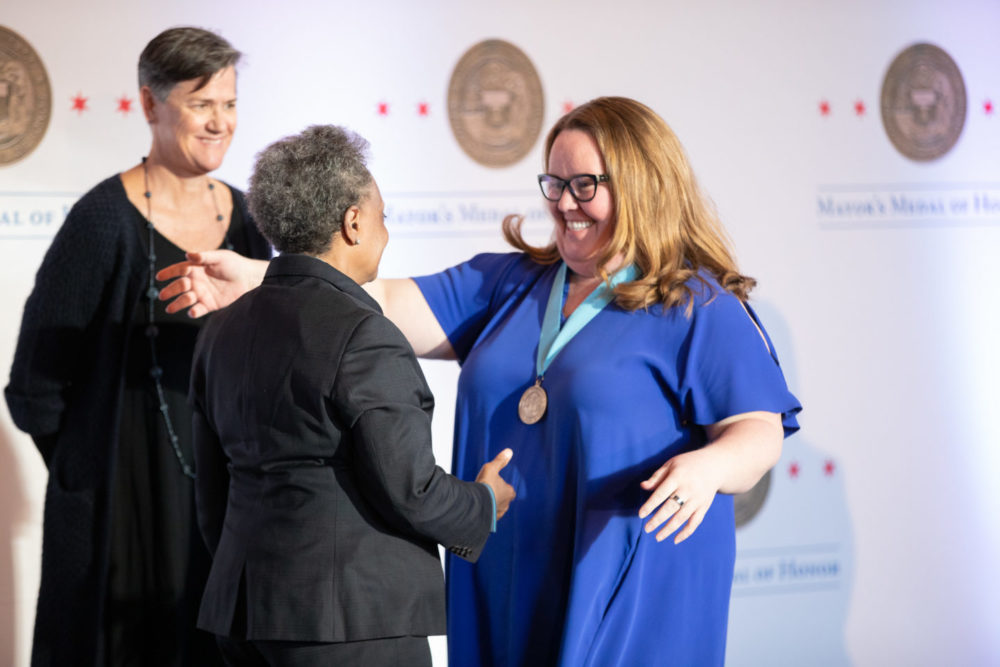 Nourishing Hope CEO Kellie O'Connell receives the Mayor's Medal of Honor on behalf of Nourishing Hope. 